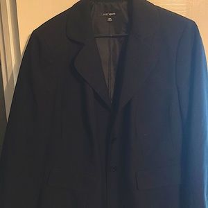 Basic black blazer, two button, falls slightly below the waist.